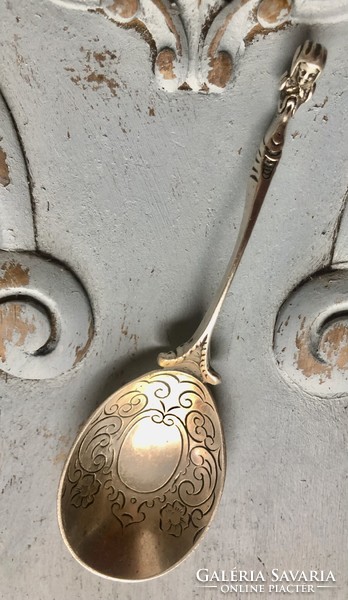 A specially decorated silver spoon with a unique shape