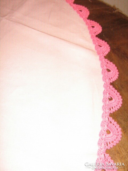 Beautiful pink hand-crocheted round woven tablecloth with lacy edges