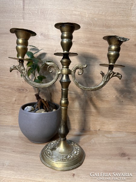 Old Russian three-pronged candle holder with a very patina
