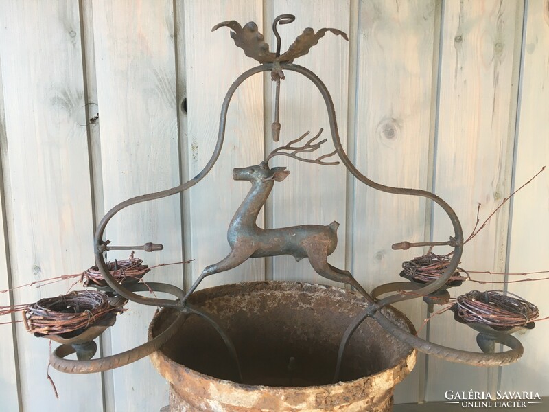 Hanging old iron candle holder with deer