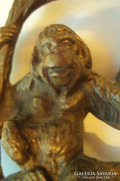 Figure of a monkey sitting on a brass branch, with characteristic processing. (Casting)