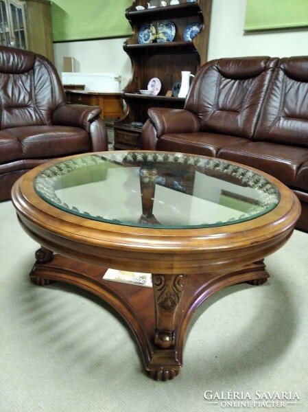 Colonial style coffee table with a large glass top, manufactured by American ashley.