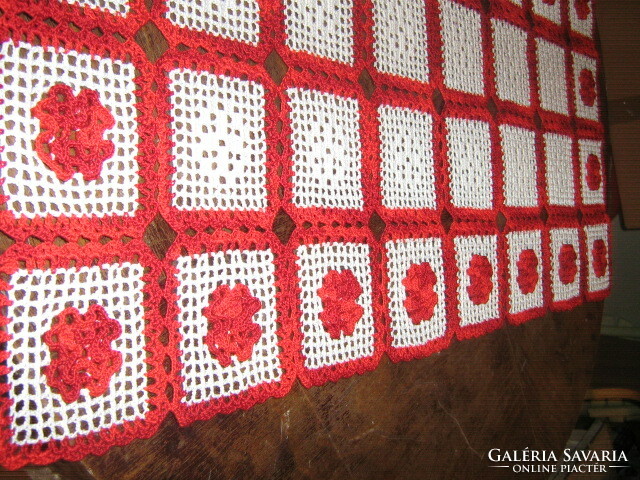 Beautiful hand-crocheted white and red tablecloth with a floral pattern
