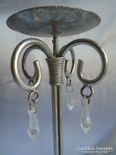 Wrought iron candle holder. Its height is 38.5 cm.