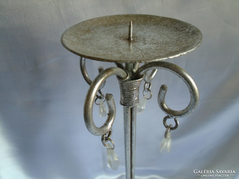 Wrought iron candle holder. Its height is 38.5 cm.