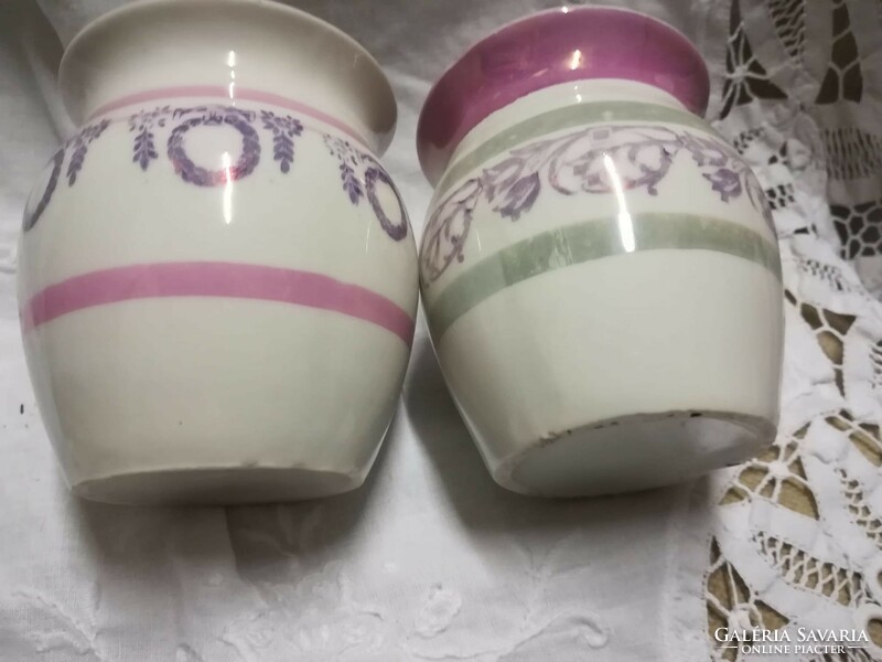 A pair of porcelain mugs with a similar pattern