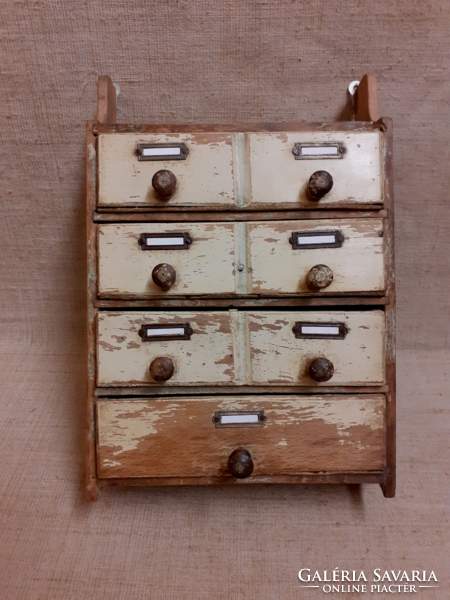 Old small wall-mounted multi-drawer spice cabinet