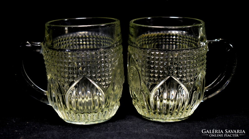 2 small glass mugs with a rooster relief pattern