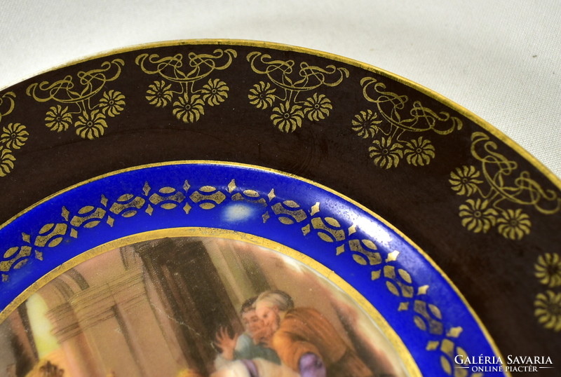 A porcelain decorative plate with historicizing scene marked Alt Wien