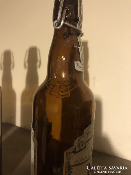 3 beer bottles with buckles