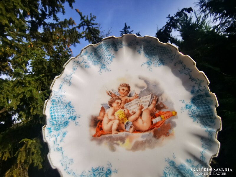 Antique decorative bowl with putto reading sheet music