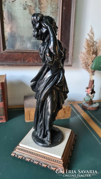 Female statue, on a marble base