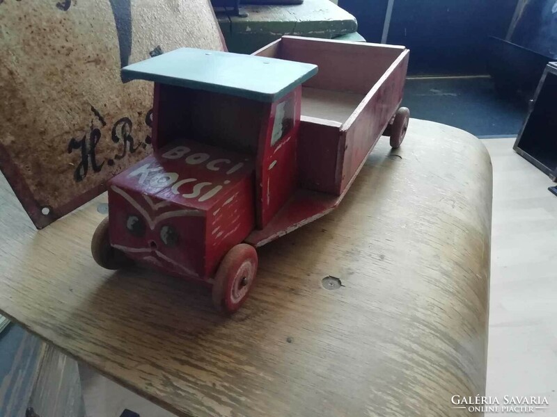 Wooden van from the 1960s with a public sign on the side and unique decoration, retro toy