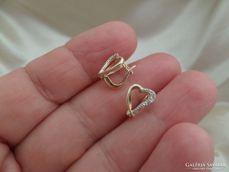 Gold heart earrings with a couple of small diamonds