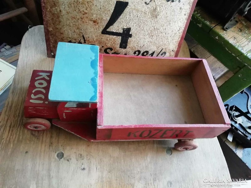 Wooden van from the 1960s with a public sign on the side and unique decoration, retro toy