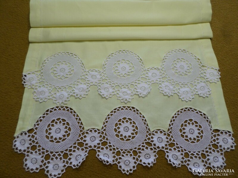 Pale yellow linen dresser tablecloth with snow-white crocheted lace at both ends, silk embroidery on the edge.