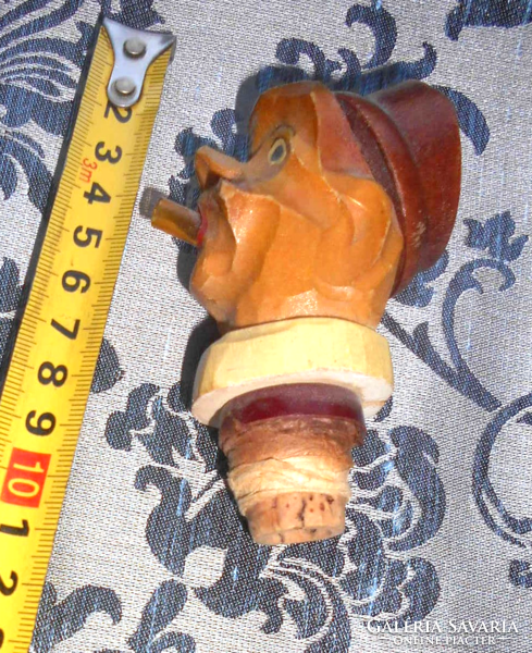 Antique carved stopper with spout on the mouth