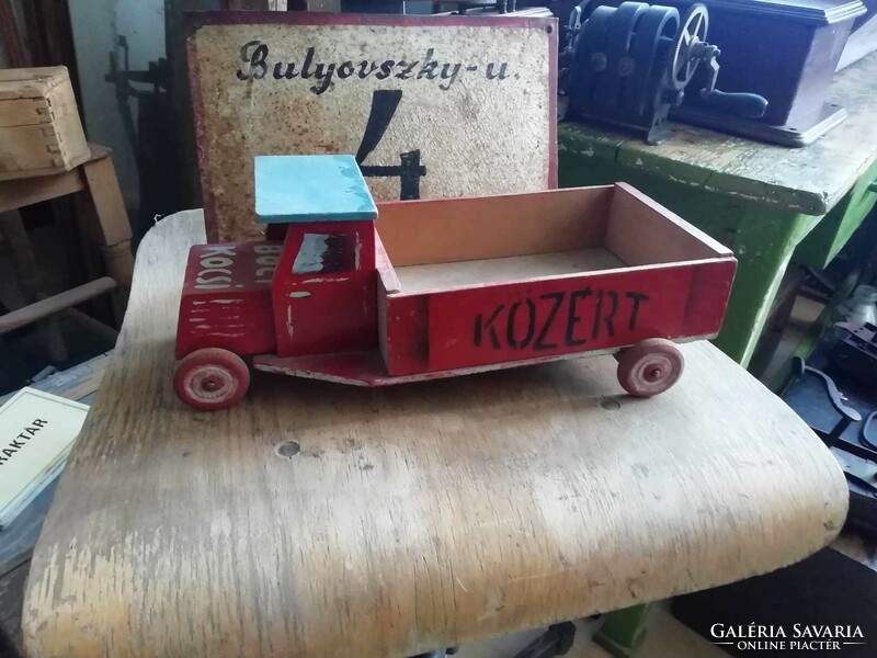 Wooden van from the 1960s with a public sign on the side and unique decoration, retro toy