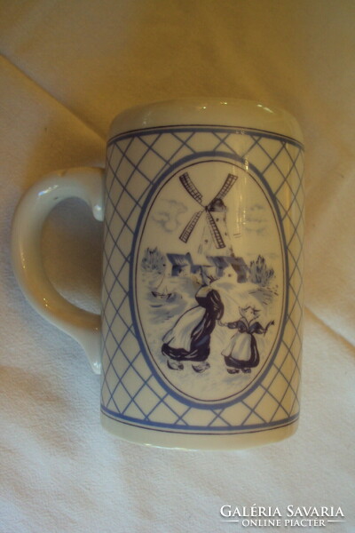 Blue, lowland porcelain beer mug with a Dutch figural motif.