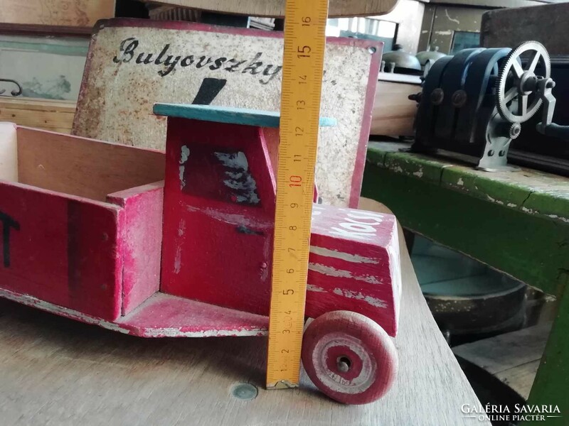 Wooden van from the 1960s with a public sign on the side and unique decoration, retro toy