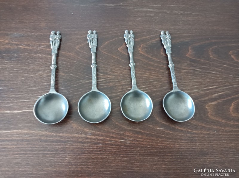 4 tin spoons marked