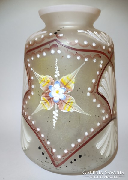 The painted opal bay glass vase, decorated with plastic flowers, has a good body