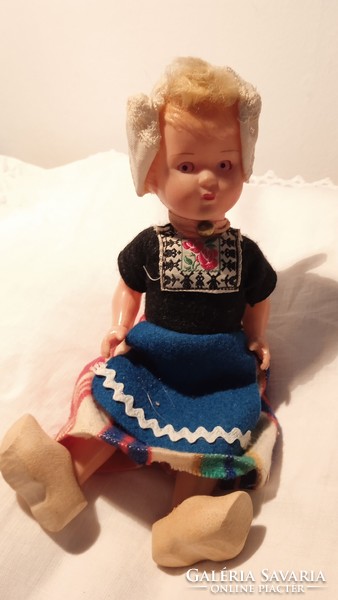 Old rubber sleeping doll in folk costume