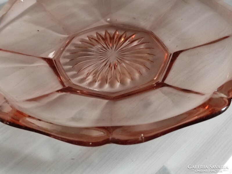 A pink engraved antique glass cake plate in the shape of a flawless flower