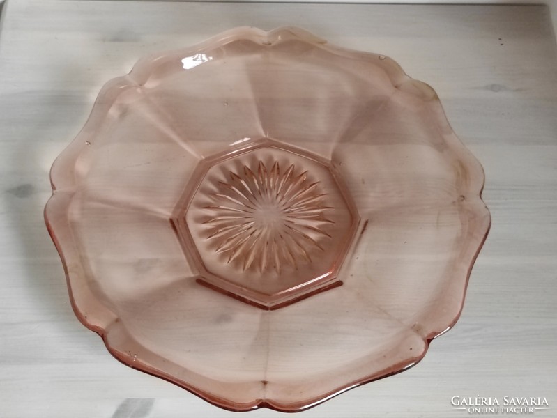 A pink engraved antique glass cake plate in the shape of a flawless flower