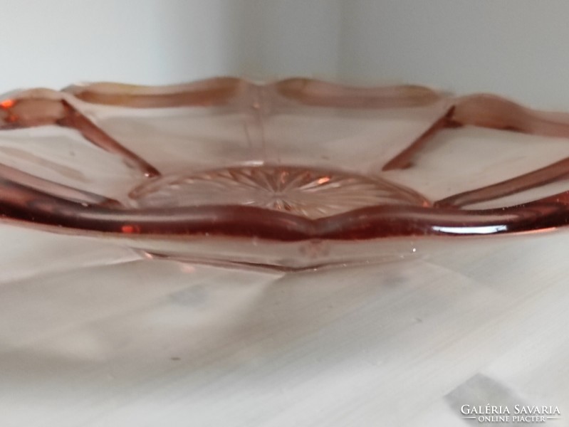 A pink engraved antique glass cake plate in the shape of a flawless flower