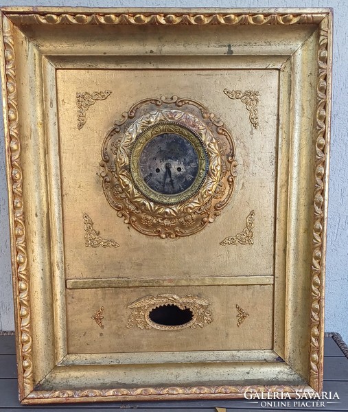 Antique Biedermeier frame clock in an ox-eye laminated frame. Wall clock.