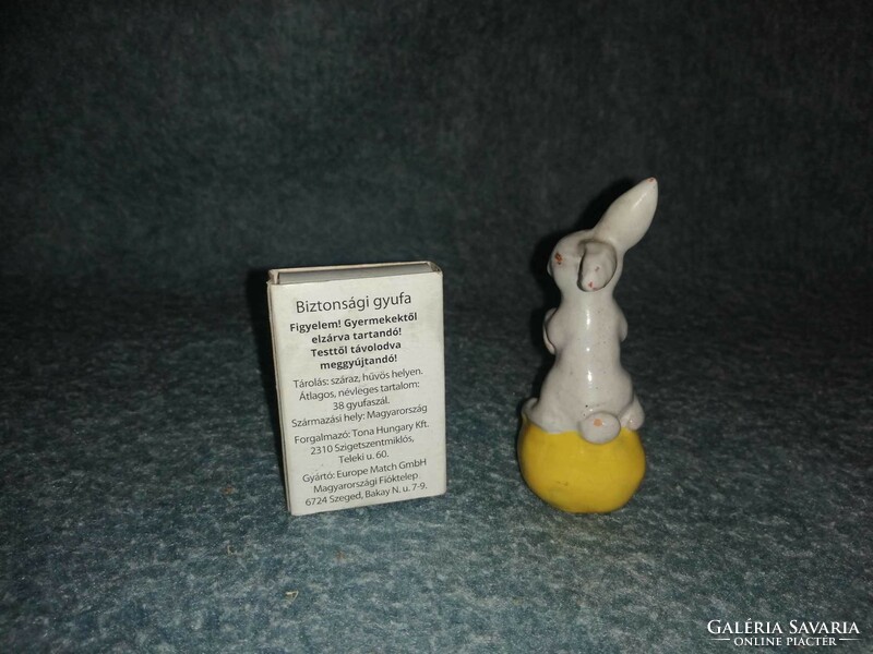 Glazed ceramic bunny on egg