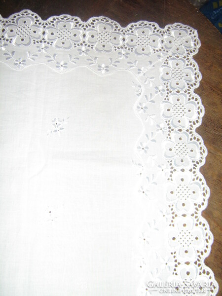 Beautiful elegant white madeira lace tablecloth on the edge