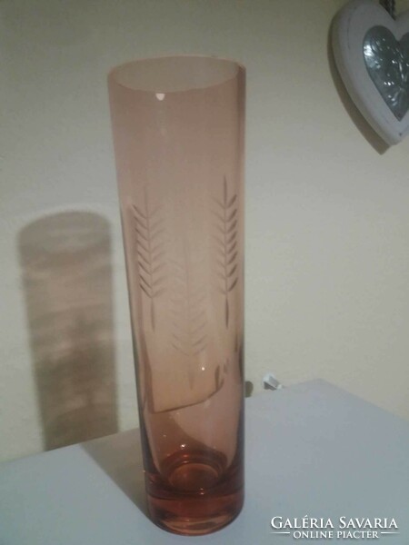 Old, coral colored, polished glass vase