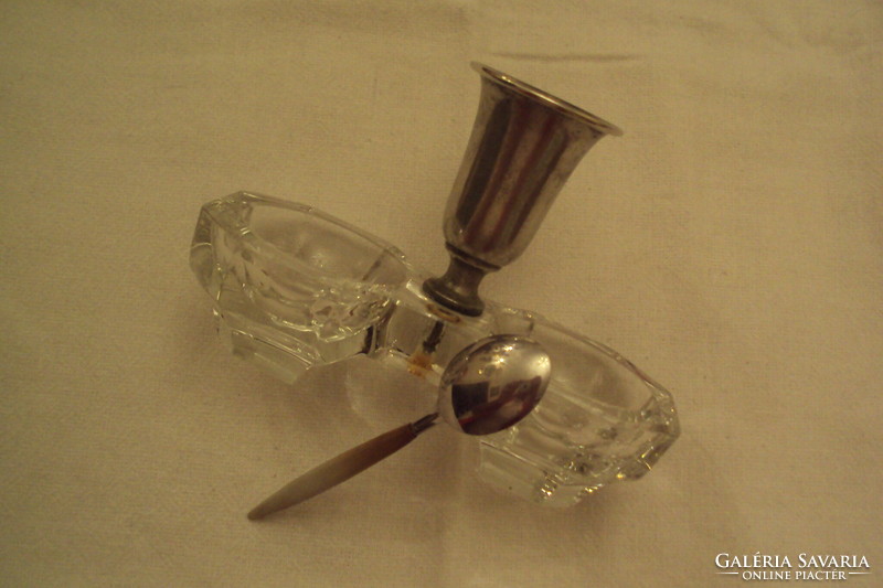 A pair of spice holders (salt holders) made of cast glass, with a silver-plated spoon holder in the middle and a spoon with a small bone handle.