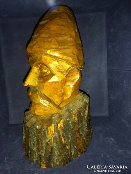 A peasant man, carved from wood, wearing a large folk hat. Wooden sculpture!