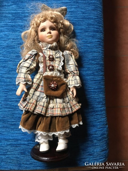 Beautiful blonde porcelain doll on a stand!