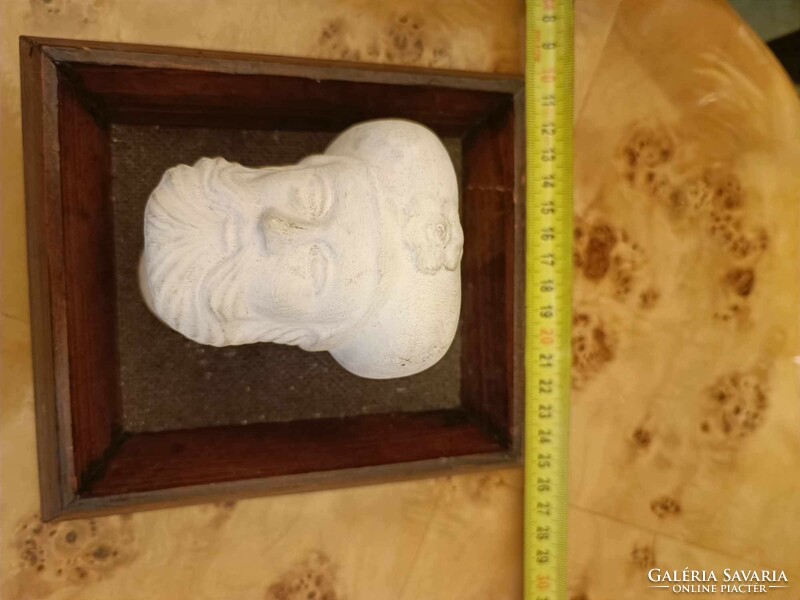 Plaster head in frame