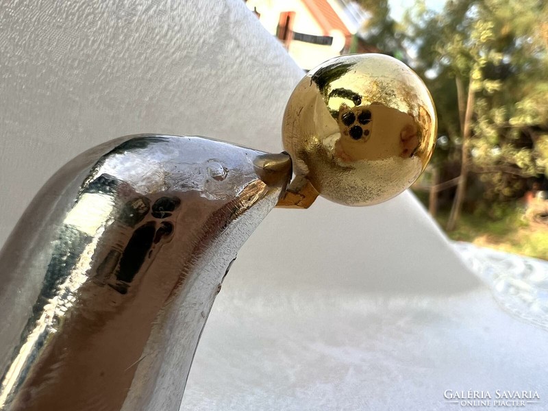 A seal playing with a ball is a special lighter and bottle opener