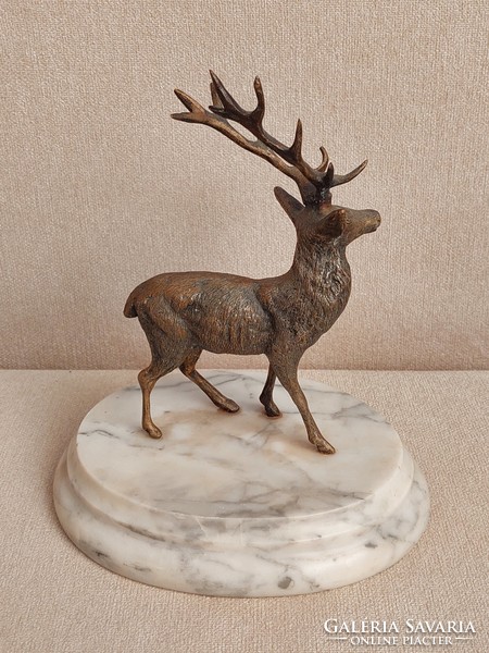 Old bronze deer statue on a marble base in perfect condition