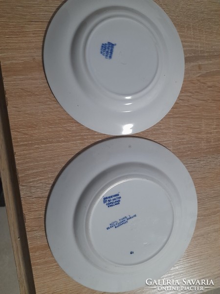 2 small plates with the label Bradford Copeland