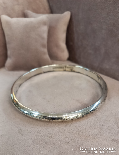 Antique silver bracelet with an engraved pattern