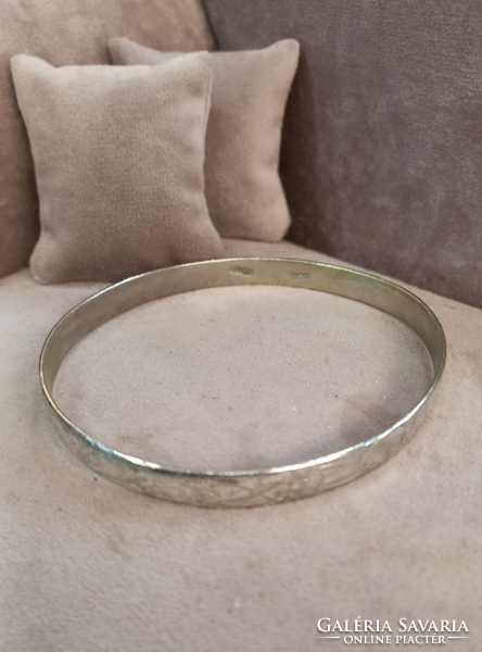 Antique silver bracelet with an engraved pattern