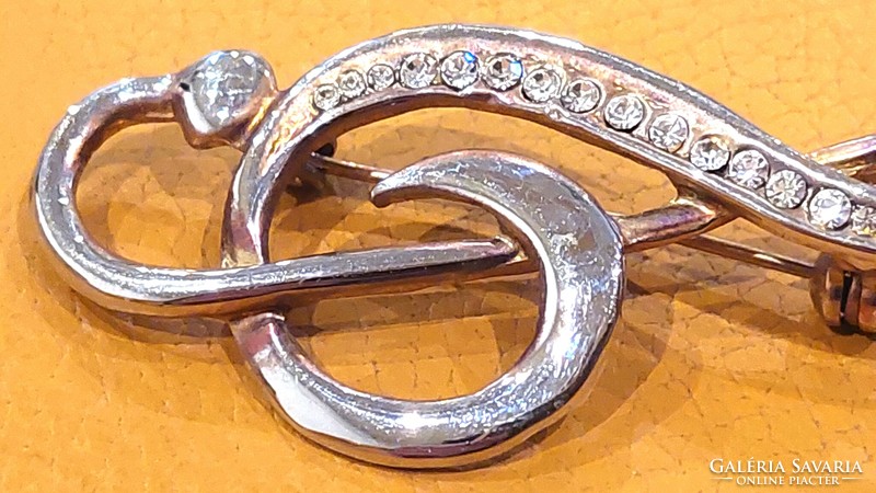 Treble clef shaped brooch decorated with stones