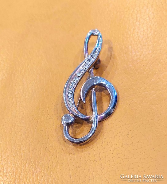 Treble clef shaped brooch decorated with stones