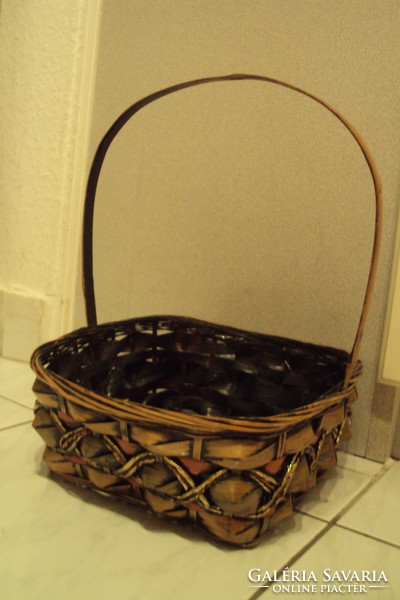 Rectangular storage basket made of brown-gold cane, lacquered with handles.