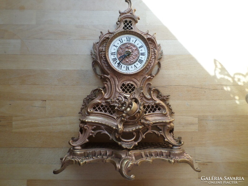 Old copper decorative Rococo fireplace clock with mechanical clock mechanism