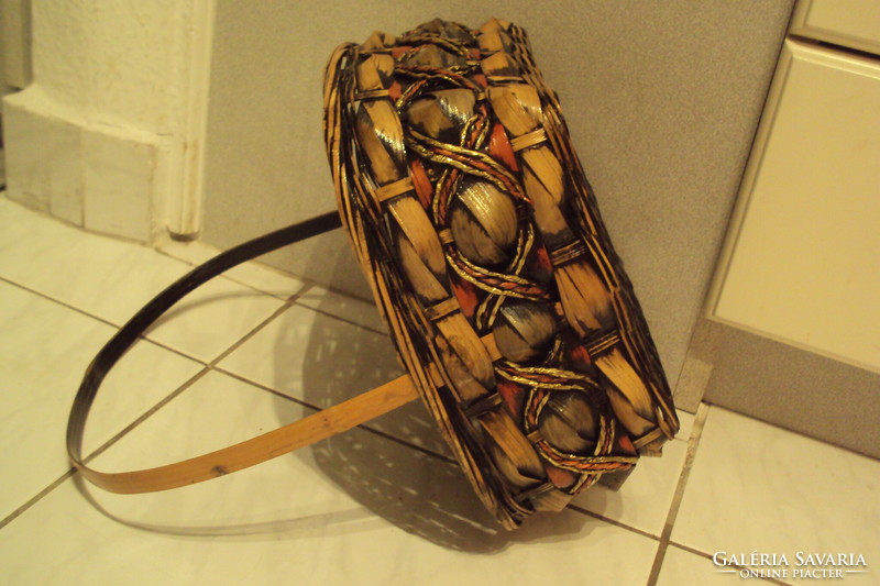 Rectangular storage basket made of brown-gold cane, lacquered with handles.