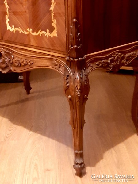 A wonderful baroque high-legged chest of drawers decorated with hand-carvings and hand-inlays, marked piece