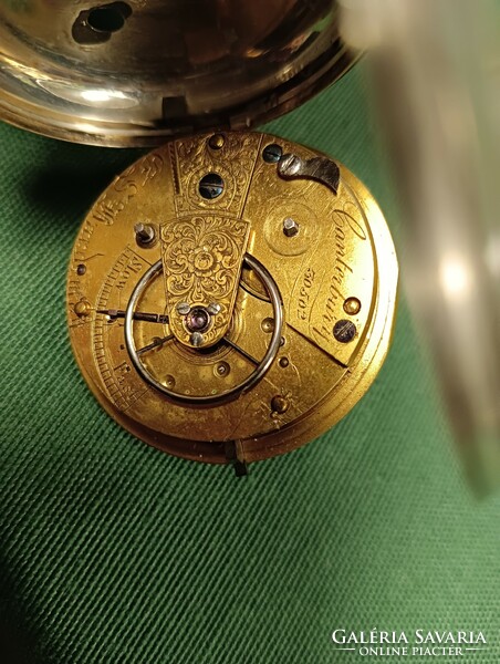 An English silver pocket watch from 1849 with a key